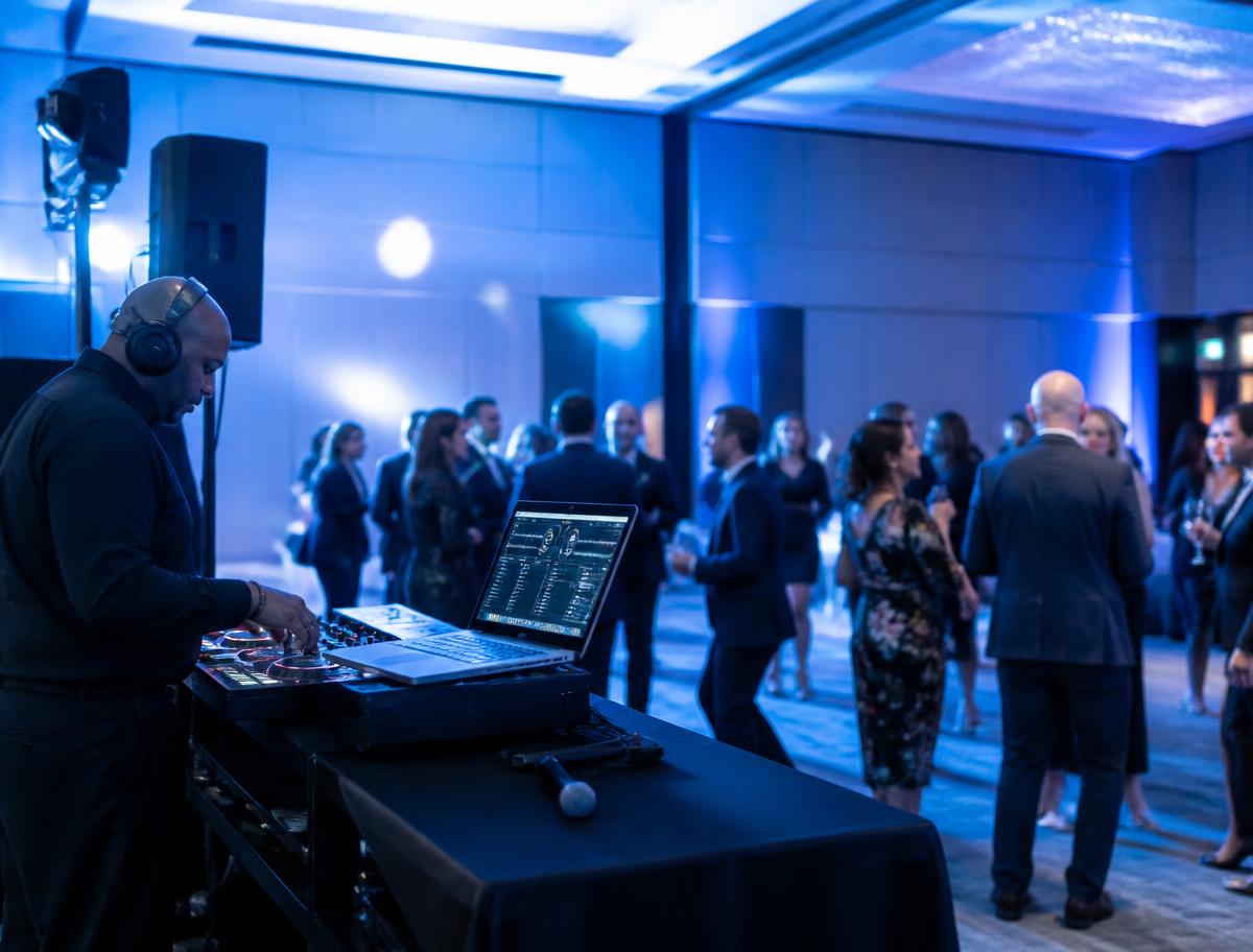 Corporate event with professional DJ setup and guests