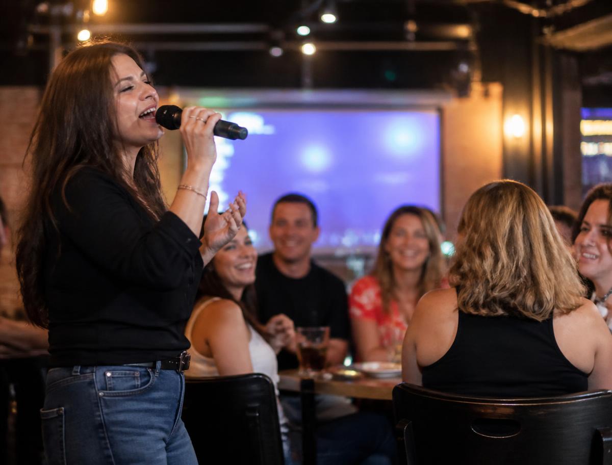 Karaoke event with a guest singing for friends